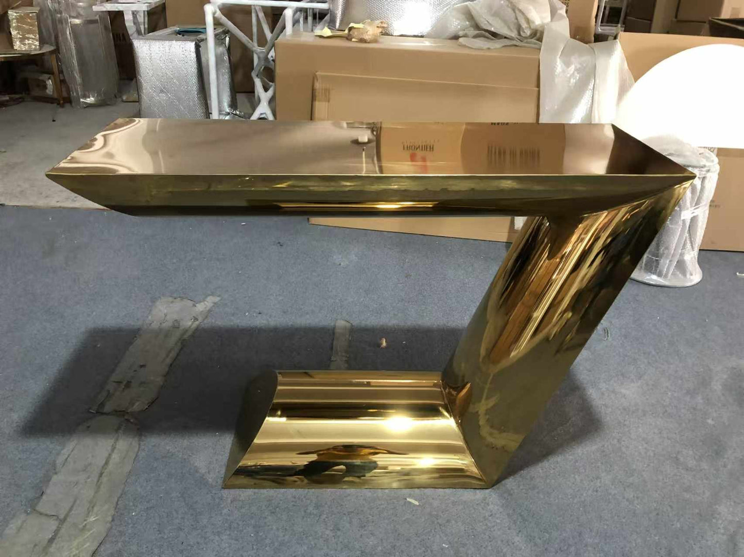 A Sleek Gold Electroplated 304 Stainless Steel Console Table with a Striking Z-Shaped Design Adds a Touch of Modern Sophistication Furniture