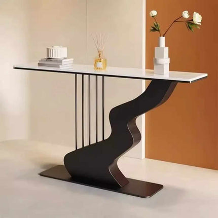 Modern console table with a white top and black base in a room setting.