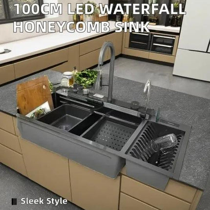 Gray kitchen sink with waterfalls and honeycomb design in a modern kitchen setting.