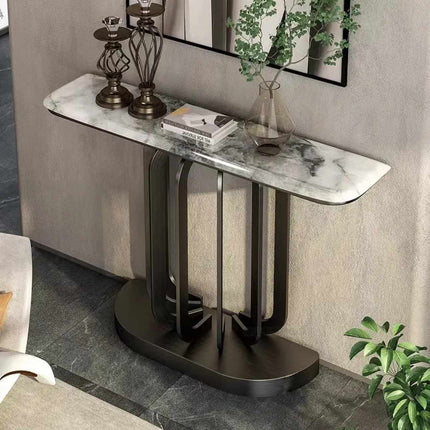 Modern console table with marble top and black metal base in a room setting.