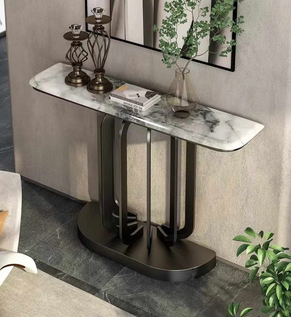 Modern console table with marble top and black metal base in a room setting.