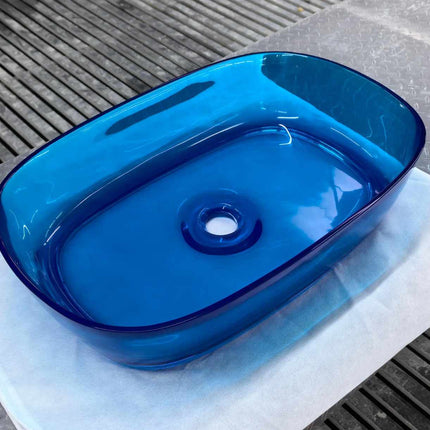 Blue glass basin on a textured surface