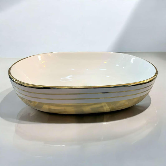 Oval Tabletop Wash Basin with Pristine White Interior Gleaming Gold Base and Refined Gold Striped Accents