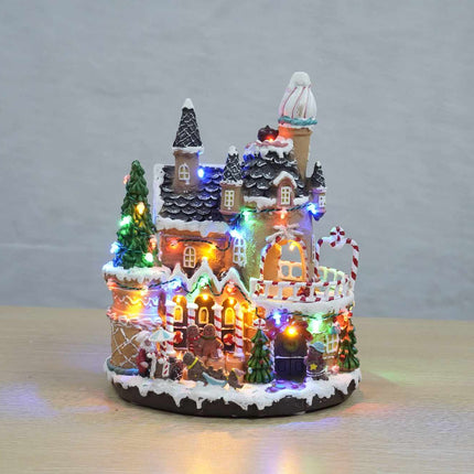 Weihnachtsdekoration: Lebkuchenhaus mit beweglichen Lebkuchenfiguren, beleuchtetes Weihnachtsdorf 