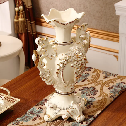 Decorative white vase with gold accents on a table