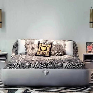 Modern Luxury Bedroom with Zebra-Print Upholstered Bed, High-Gloss Black and Gold Accented Chairs, Velvet and Silk Bedding, Custom Abstract Rug, and Elegant Pendant Lighting