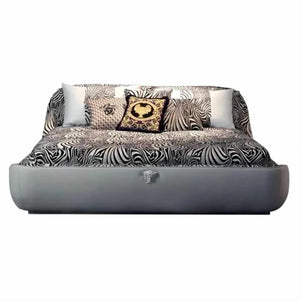 Modern Luxury Bedroom with Zebra-Print Upholstered Bed, High-Gloss Black and Gold Accented Chairs, Velvet and Silk Bedding, Custom Abstract Rug, and Elegant Pendant Lighting