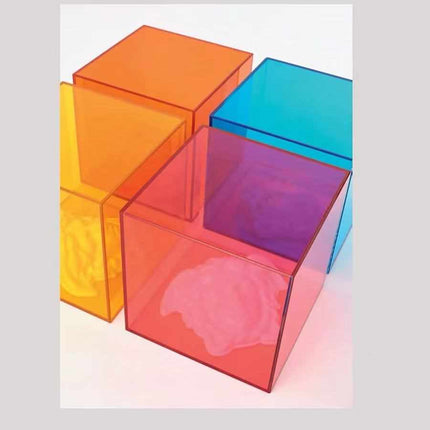 Acrylic Cubes in Vibrant Hues of Orange, Blue, Red, and Yellow, Showcasing Light Refraction and Shadow Play