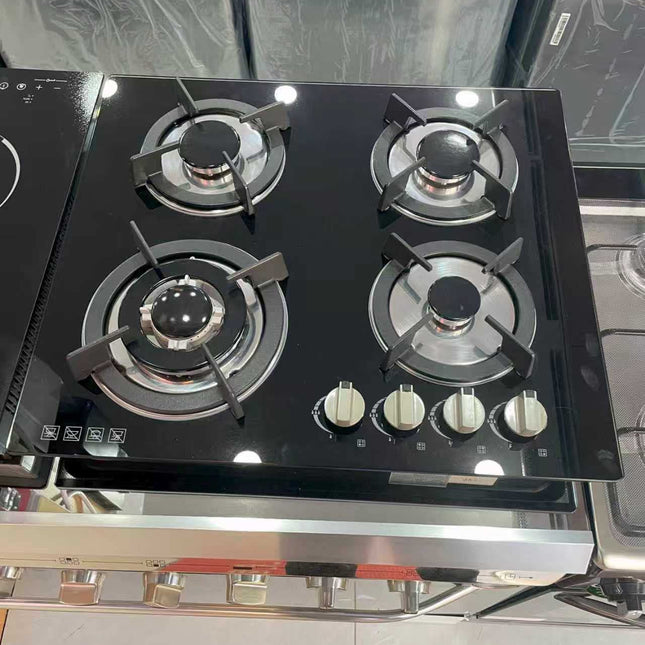 Gas stove with four burners and control knobs on a kitchen counter.
