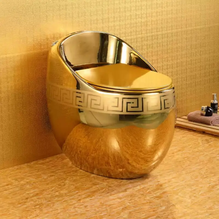 Gold-colored toilet bowl with decorative patterns in a bathroom setting.