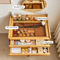 A bamboo cosmetic organizer cabinet with a movable mirror, sinking storage, recessed storage, and an open drawer labeled as a makeup area, shown filled with cosmetics and skincare products in a home setting.