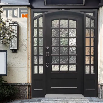 Black decorative door with glass panels on a building facade, featuring the brand 'Tufine'.