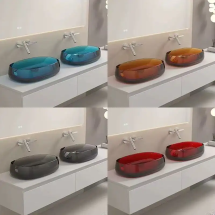 Four different colored glass sinks on a white countertop with silver faucets.