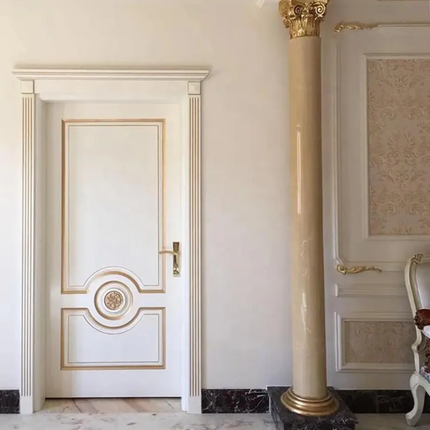 Decorative interior with a white door and gold accents, featuring a column and ornate wall design.