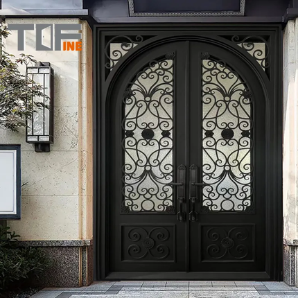 Decorative black wrought iron door with intricate patterns on a building facade.