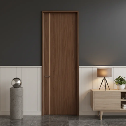 Wooden door in a room with a lamp and plant on a side table.
