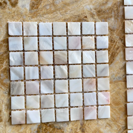 Square mosaic tiles on a marble surface