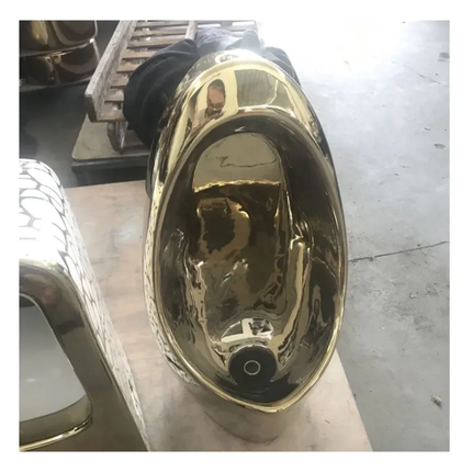 Gold exhaust tip on a concrete floor with a blurred background