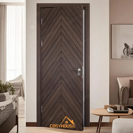 Wooden door with chevron pattern in a modern living room, featuring the Cosyhouse brand.