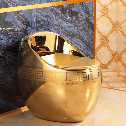 Gold decorative vase with intricate design on a marble surface