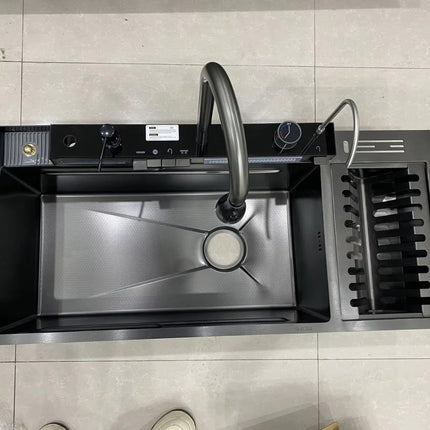 Stainless steel kitchen sink with faucet on a tiled countertop