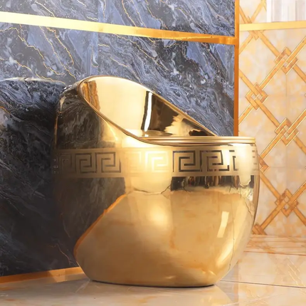 Gold decorative vase with intricate patterns on a marble surface