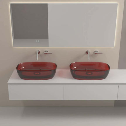Bathroom vanity with two red glass sinks and a mirror.