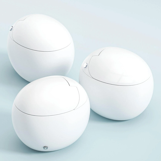 Three white spherical objects on a light blue background