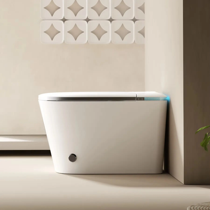 Modern freestanding bathtub against a neutral wall with decorative tiles.
