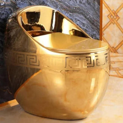 Gold decorative urn with intricate patterns on a textured surface
