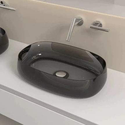 Black sink on a white countertop with silver faucet