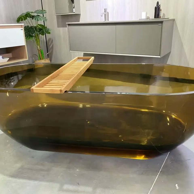Modern glass bathtub with a wooden tray in a bathroom setting
