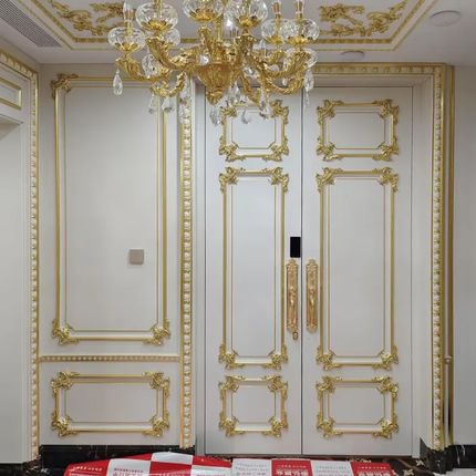 Decorative interior with gold molding and a chandelier