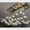 Ceiling-mounted chandelier with floral design on a gray ceiling