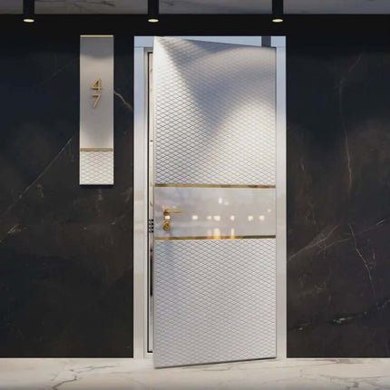 Modern door with textured design and gold accents on a dark marble wall.