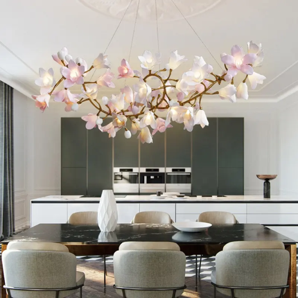 Modern kitchen with a decorative floral chandelier above a dining table.