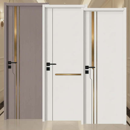 White interior door with gold accents and black handles in a room setting.