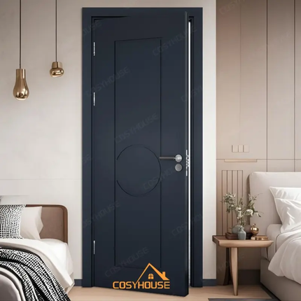 Modern bedroom with a dark blue door, bed, and side table.