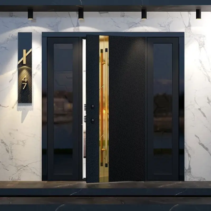 Modern black door with gold handle on a marble wall