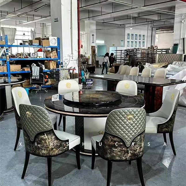 Luxurious Round Dining Table Stainless Steel Set with Black Marble Top, Elegant Quilted Leather and Wood-Inlaid Chairs, and Gold Embellishments in a High-End Furniture