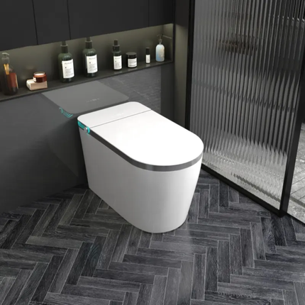 Modern white toilet in a stylish bathroom with dark tiles and minimal decor.
