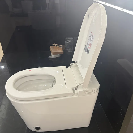 White toilet with open lid on a reflective black surface