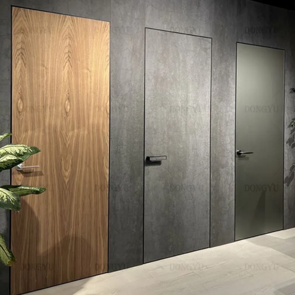 Three doors with different finishes on a gray wall, including wooden and metallic.