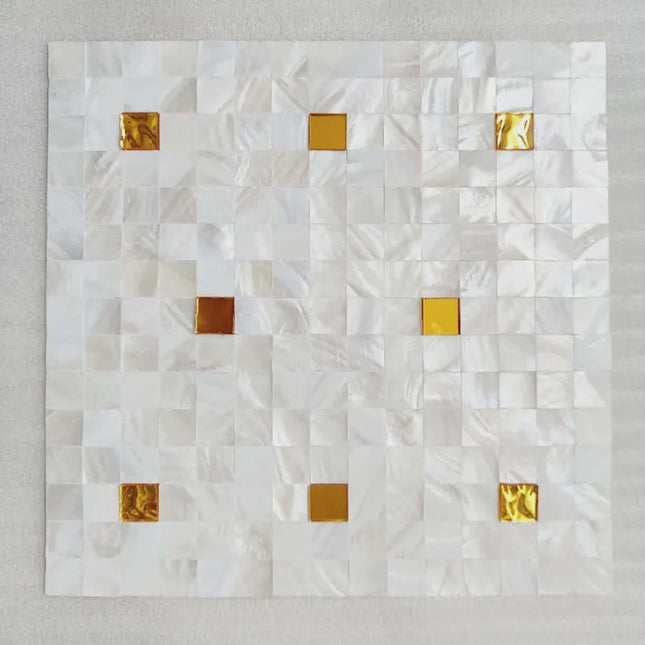 White quilt with gold square patterns on a light gray background