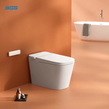 Modern toilet in a bathroom with an orange wall and white bathtub.