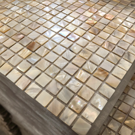 Close-up of a mosaic tile countertop with various shades of brown and beige.