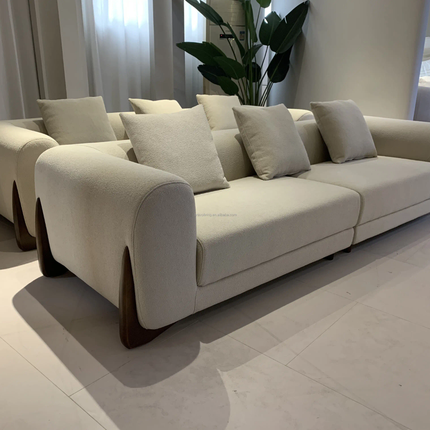Beige sofa with cushions in a modern living room setting