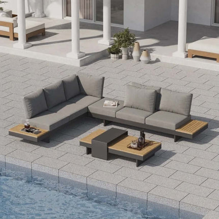 Outdoor patio furniture set with a sectional sofa and coffee table by a pool.