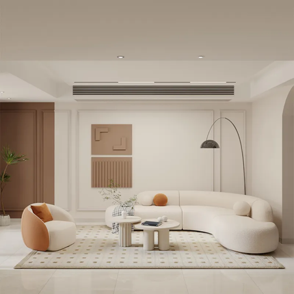 Modern living room with a curved white sofa, round coffee table, and decorative wall art.