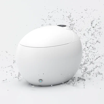 White spherical device with water droplets on a light gray background